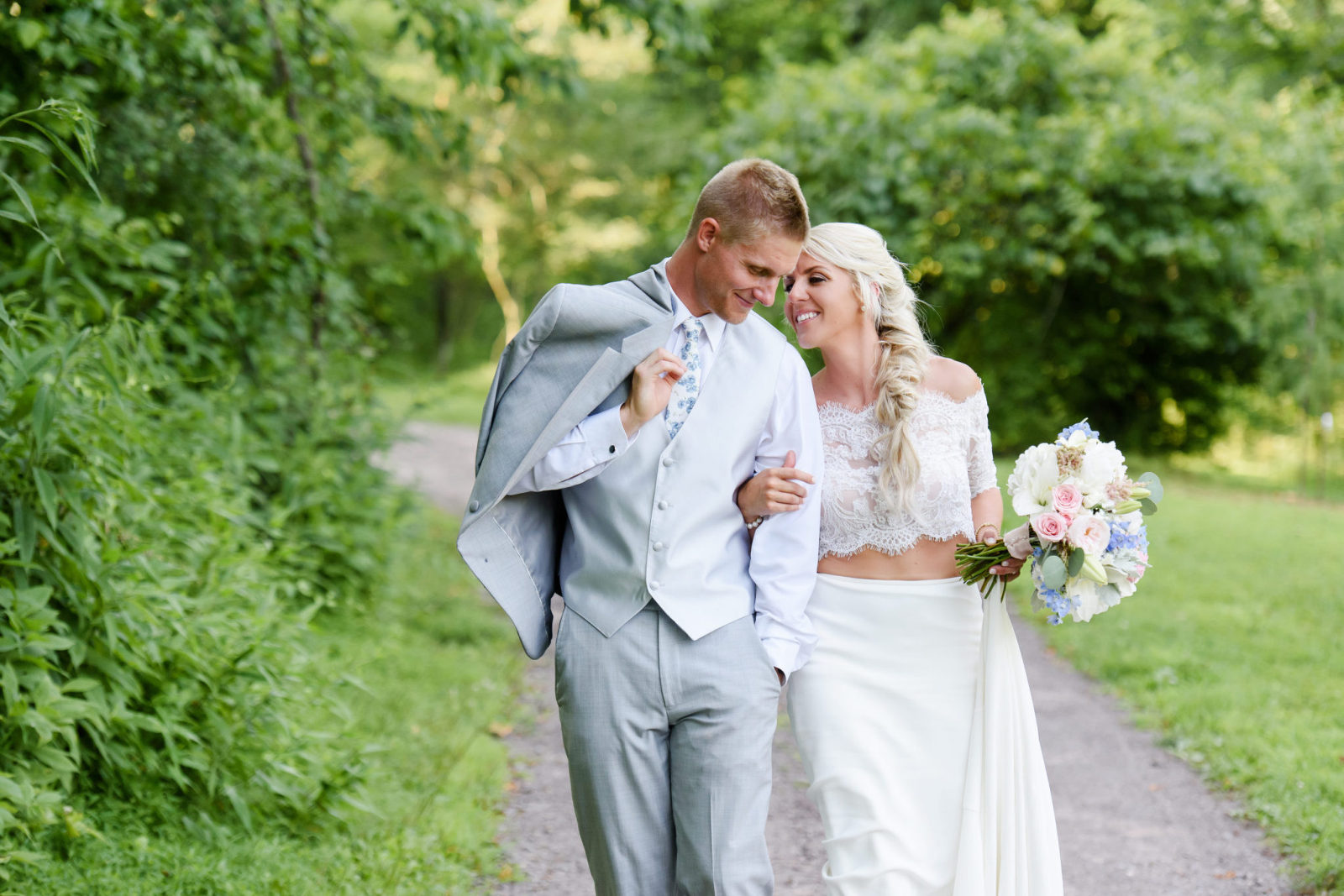 bride and groom walking through the Pittsburgh Botanic Gardens in Oakdale, Pennsylvania