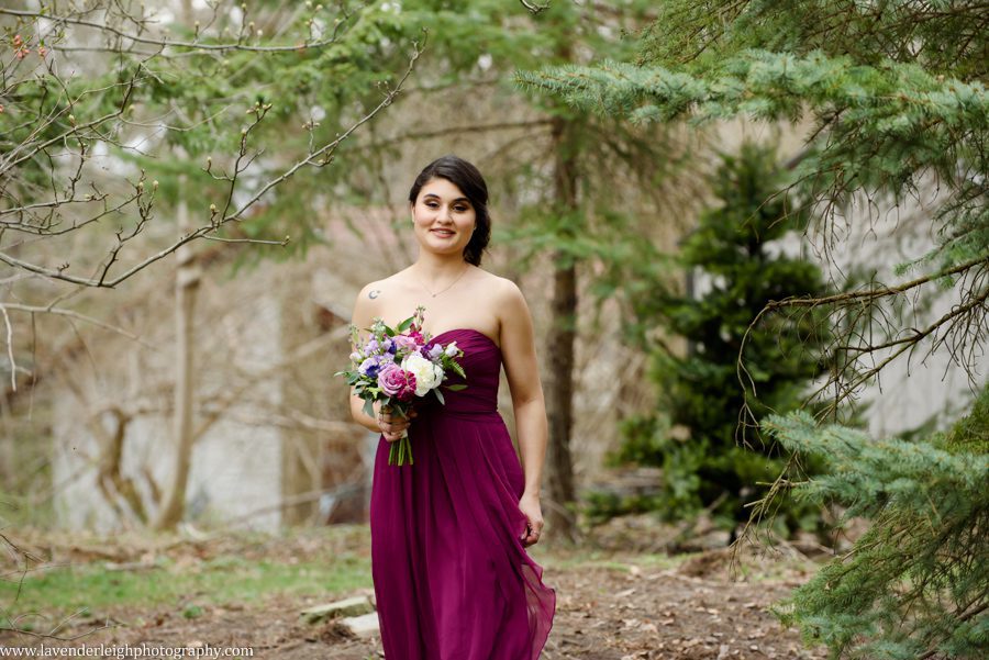 <alt> bridesmaid walking outside and down the aisle at the Hyeholde in Moon, Pennsylvania</alt>
