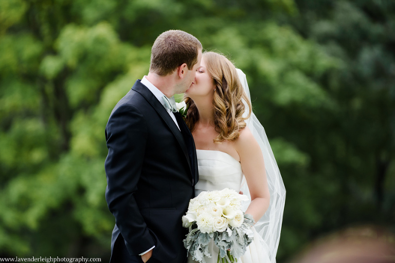 <alt> a bride and groom kissing on the golf course at the Pittsburgh Field Club in Fox Chapel, Pennsylvania </alt>