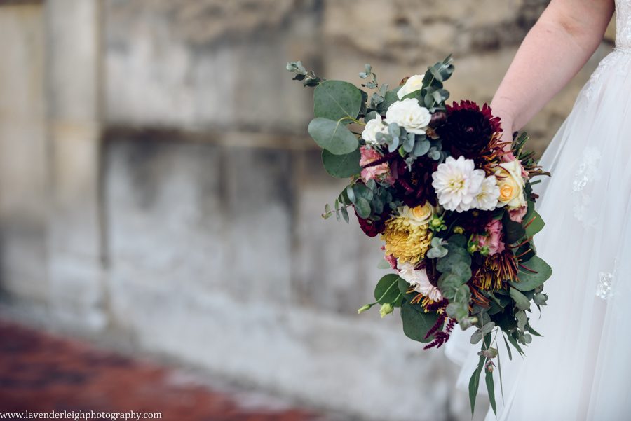 <alt> bride holding a vibrant wedding bouquet at the Heinz History Center in Pittsburgh, Pennsylvania</alt>