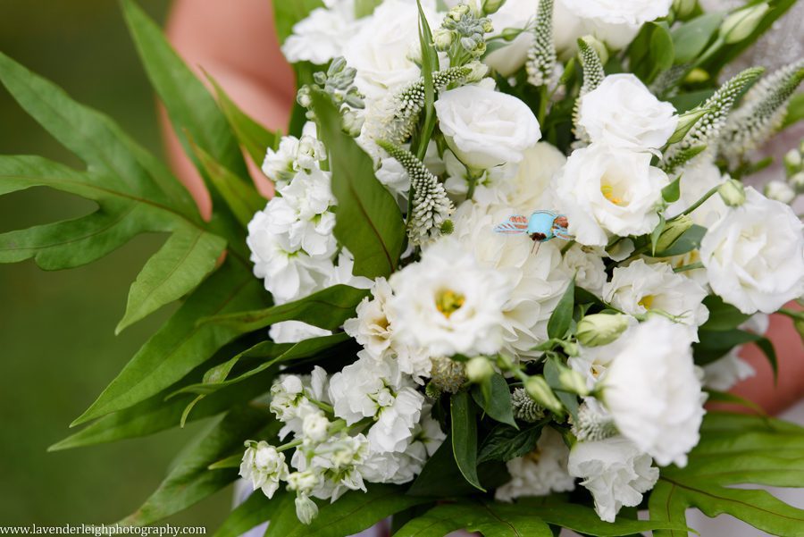 A blue bumble bee was part of the white wedding bouquet.  It was the bride's something blue.