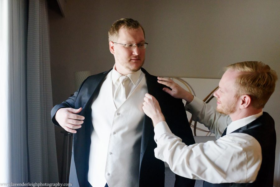 Best Man Straightens Groom's Jacket in the hotel room of the Courtyard by Marriott Settler's Ridge