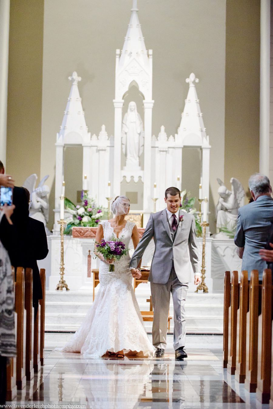 Bride and Groom During Processional at their Wedding Ceremony at the Immaculate Concpetion Parish in Washington, Pennsylvania