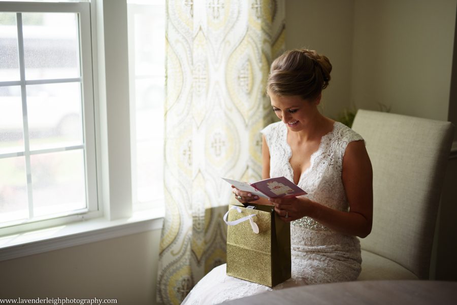 A bride reads a letter from the groom and opens his gift to her
