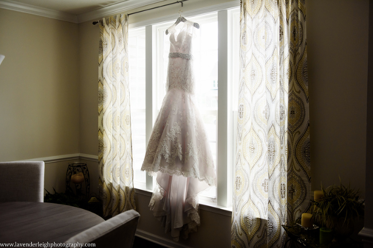 Lace Wedding Dress Hanging in Window by Lavender Leigh Photograhy