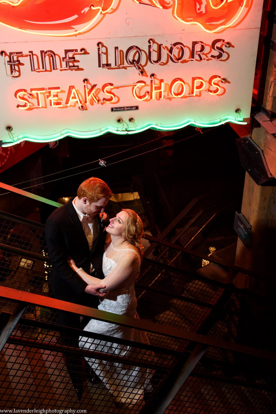 A bride and groom in the open stairwell at the Heinz History Center