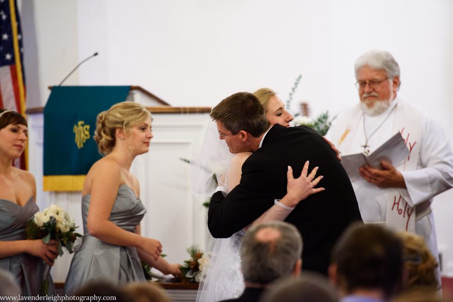A bride's father giving her away during wedding ceremony