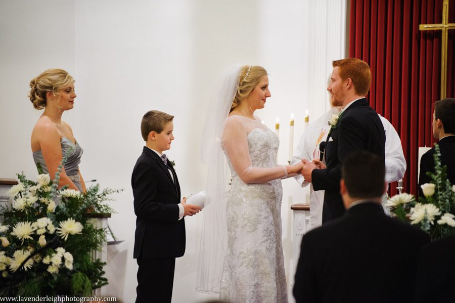 A bride and groom standing at the alter during their wedding ceremony