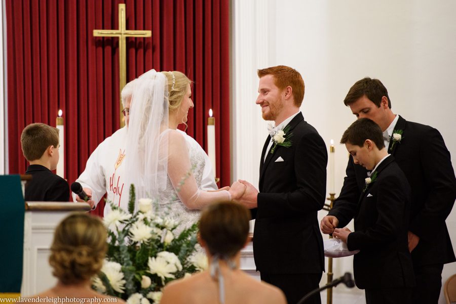 A bride and groom standing at the alter during their wedding ceremony