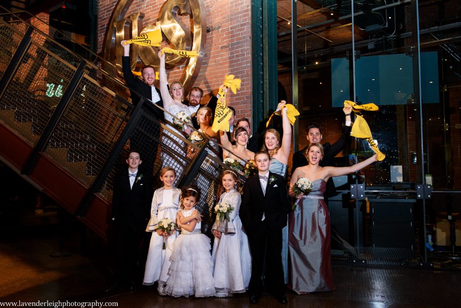 A bride, groom, and bridal party show their team spirit by waving their Pittsburgh Steelers Terrible Towels