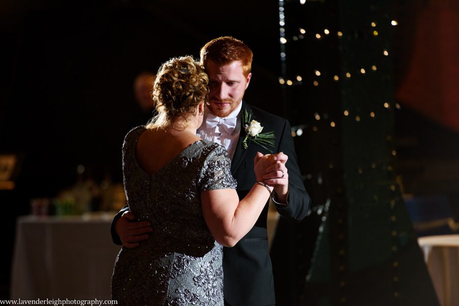 A groom and his mother dance at a wedding reception at the Heinz History Center