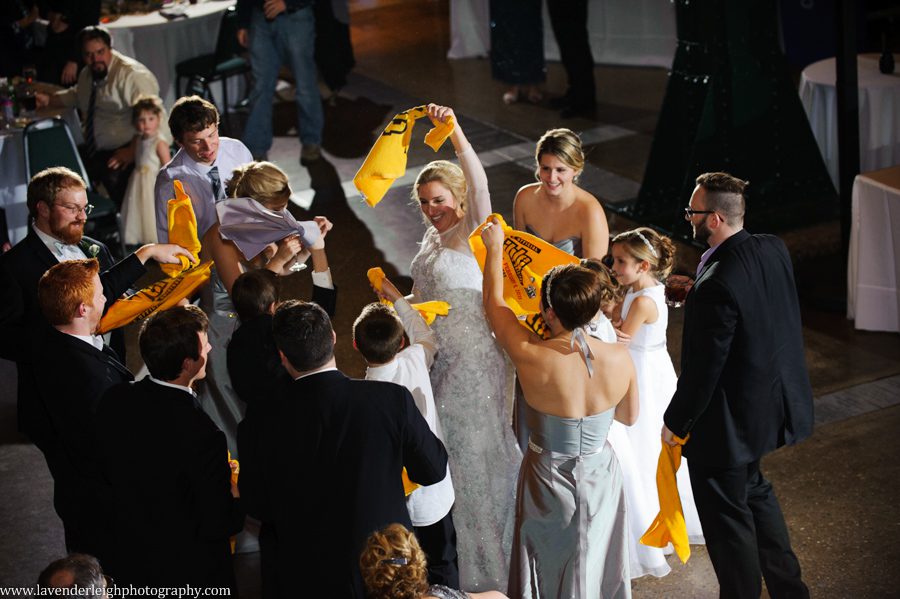 The bridal party gets introduced onto the dance floor waving their terrible towels