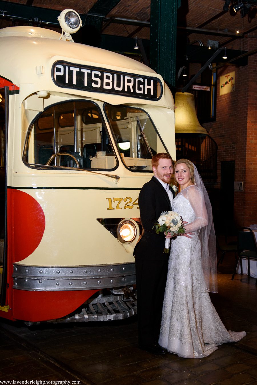Bride and Groom standing next to Pittsburgh's old historic trolley at the Heinz History Center