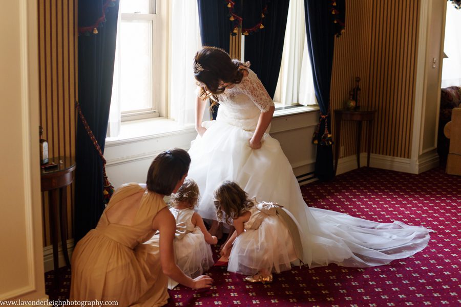 The flower girls brought out the bride's shoes and put them on her feet at the Omni William Penn in Pittsburgh, Pennsylvania
