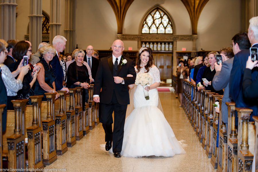 the bride and her father walk down the aisle at her wedding ceremony at St. Paul Cathedral in Pittsburgh, Pennsylvania