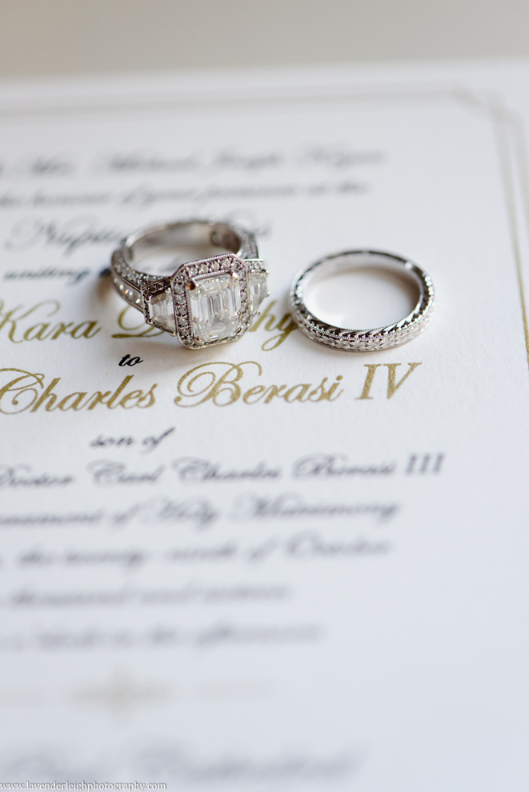 Wedding rings laid on a wedding invitation at the Omni William Penn in Pittsburgh, Pennsylvania