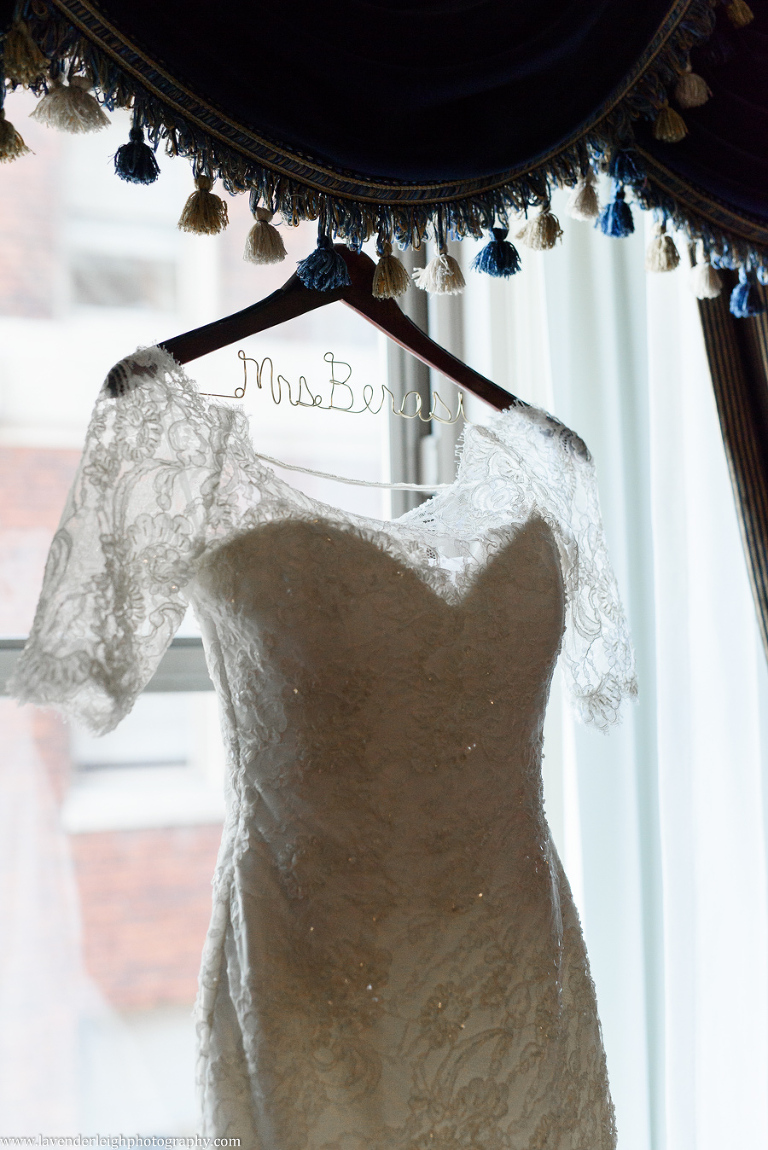 A lace wedding dress hanging in the window of the Omni William Penn in Pittsburgh, Pennsylvania