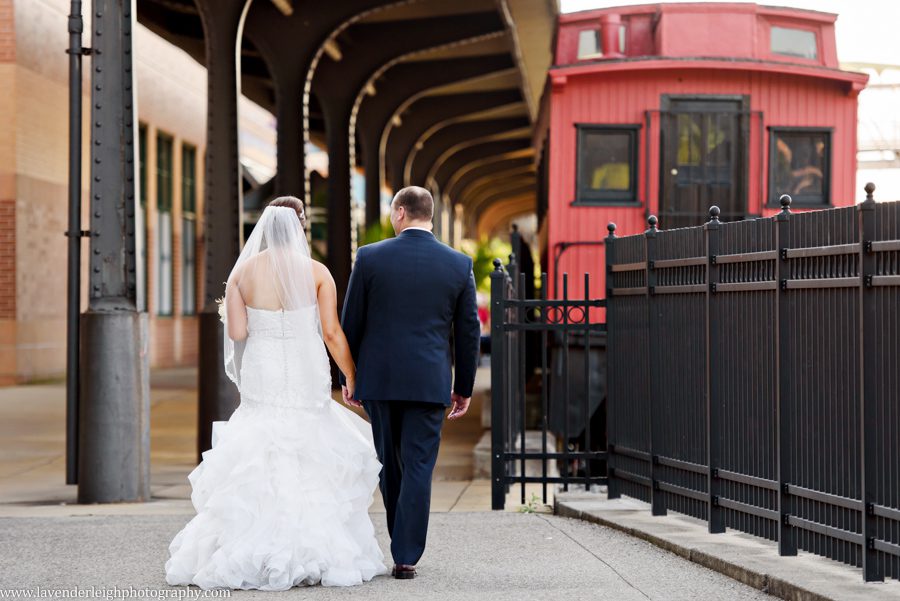 The bride and groom walk towards the red train in Station Square, Pittsburgh, Pennsylvania
