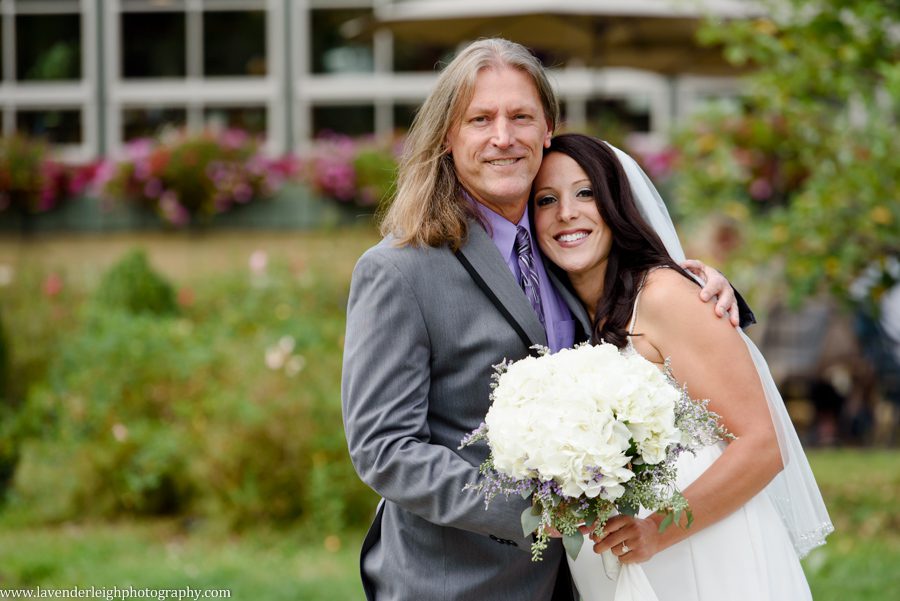 The bride and her father hug at Greendance Winery at Sandhill in Mt. Pleasant, Pennsylvania