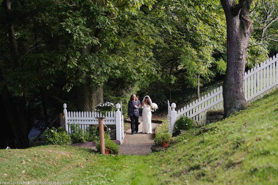 The bride and her father walk down the winding path to the ceremony site at Greendance, the Winery at Sandhill in Mt. Pleasant Pennsylvania