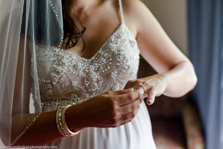 The bride slips on her engagement ring during the getting ready pictures on her wedding day