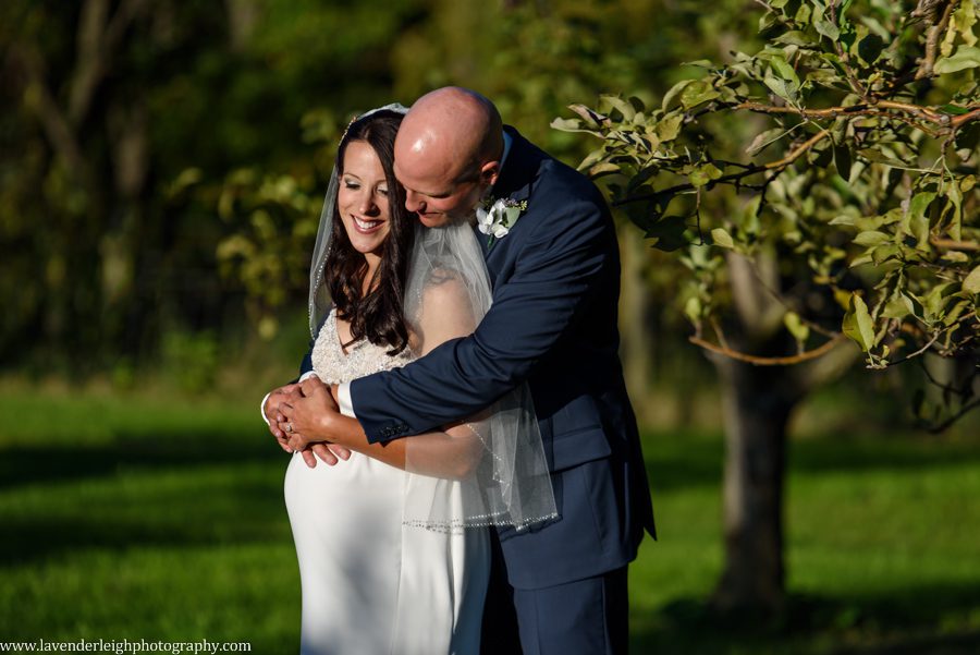 A picture of a bride and groom in an apple orchard at Greendance, the Winery at Sandhill in Mt. Pleasant, Pennsylvania