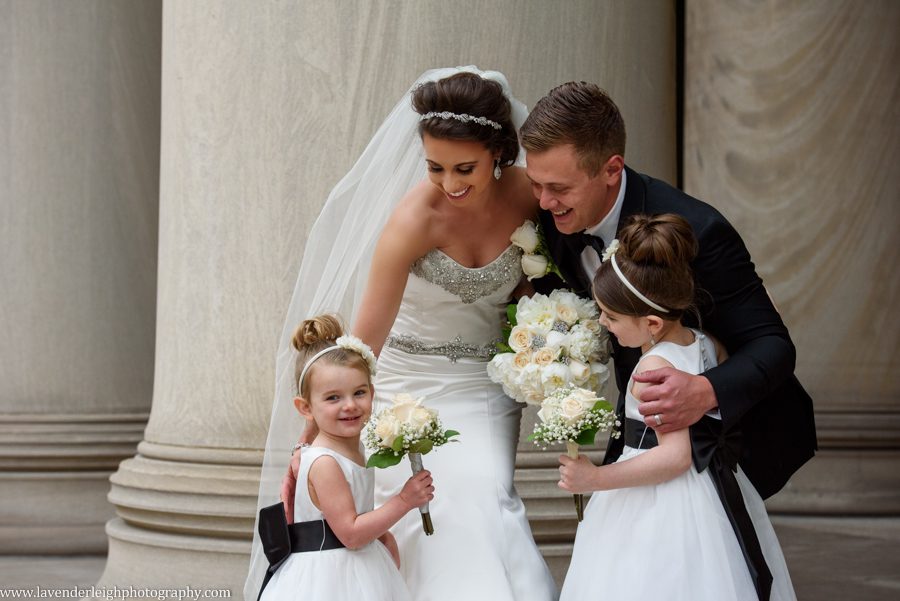 embrace, flower girls, bride, groom
