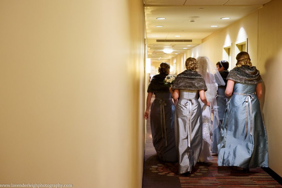 A bride and her bridesmaids leaving the hotel room for the ceremony