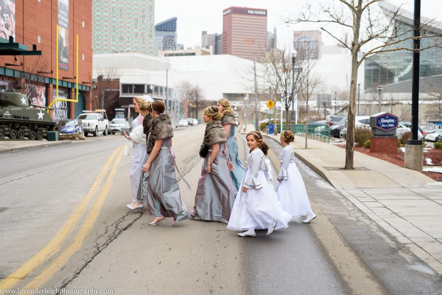 A bride, her bridesmaids, and flower girl crossing a busy street in the Strip District