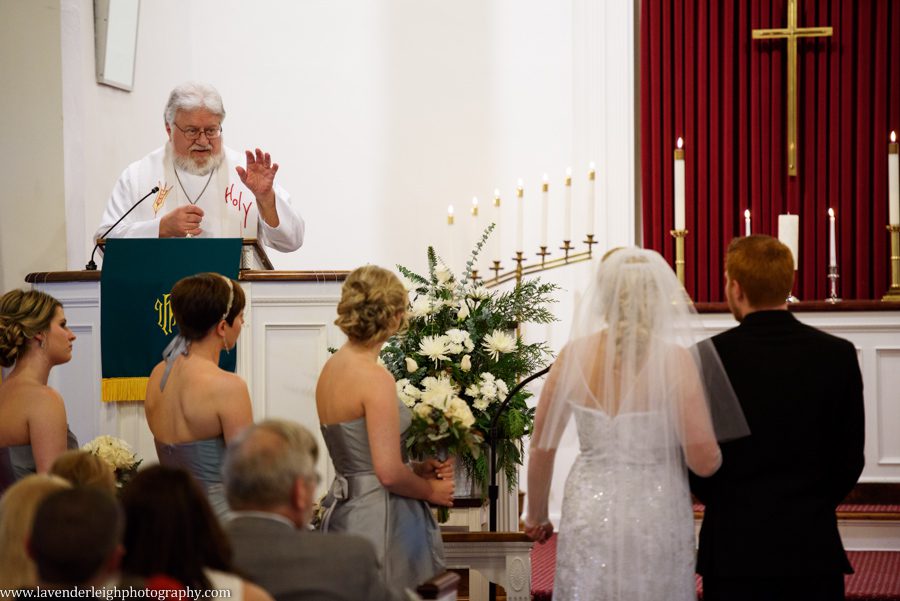 A bride and groom standing at the alter during their wedding ceremony