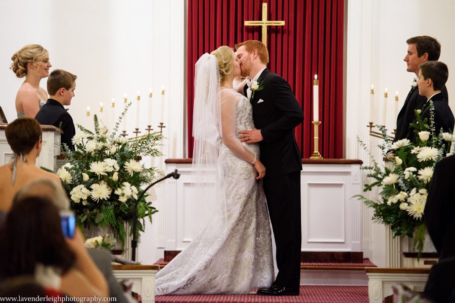 A bride and groom's kiss during ceremony