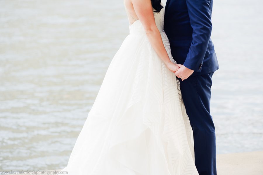 The bride and groom hold hands in Pittsburgh, Pennsylvania