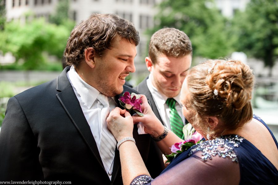 Groom Having Boutonniere Pinned
