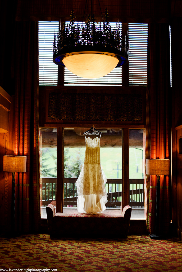 wedding dress hanging in window