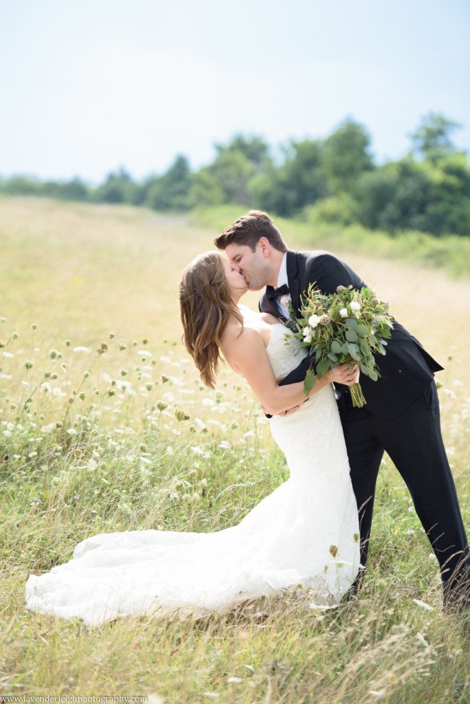 Groom Dips Bride in a Field
