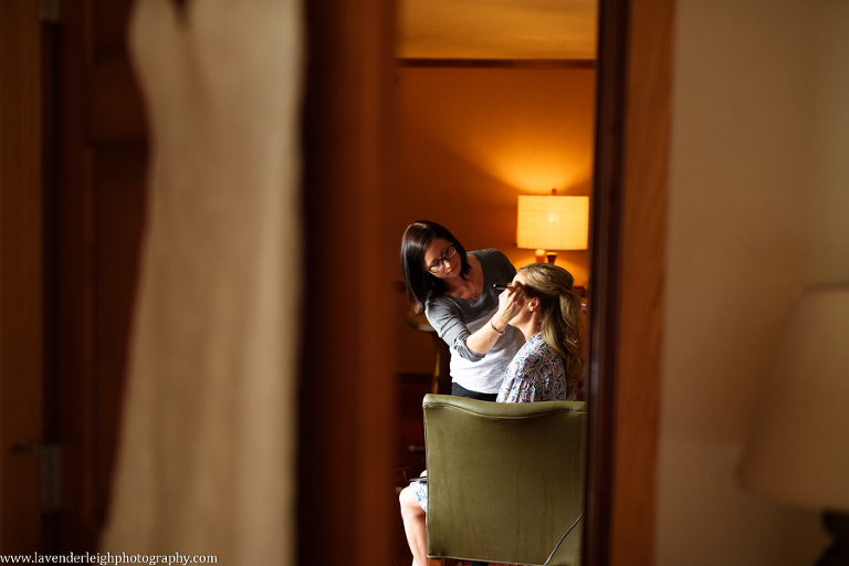 A bridesmaid is having her makeup done.