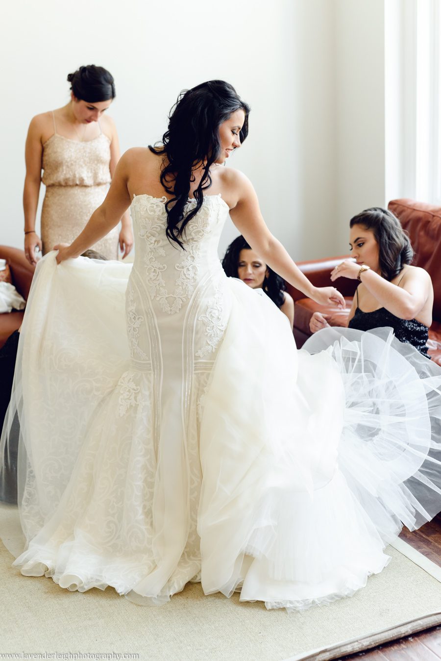 Bridesmaids Fluffing Bride's Dress
