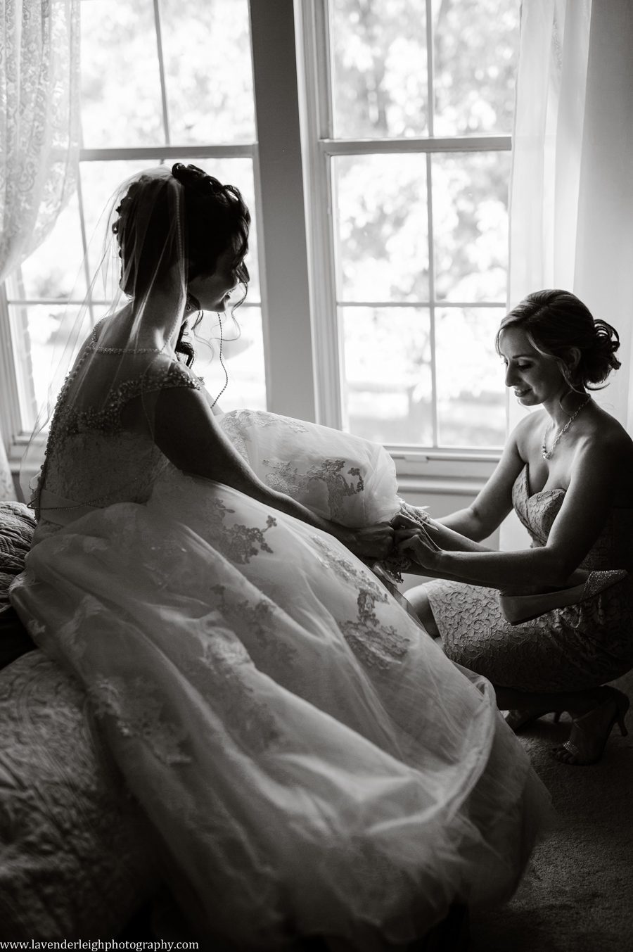 putting on wedding shoes, bride, sister