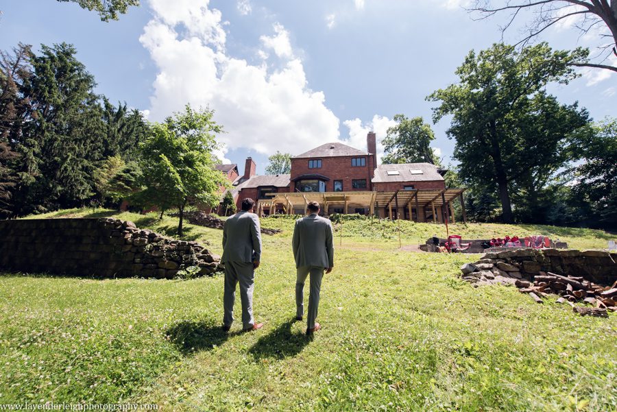 <alt>groom and best man walking towards house</alt>
