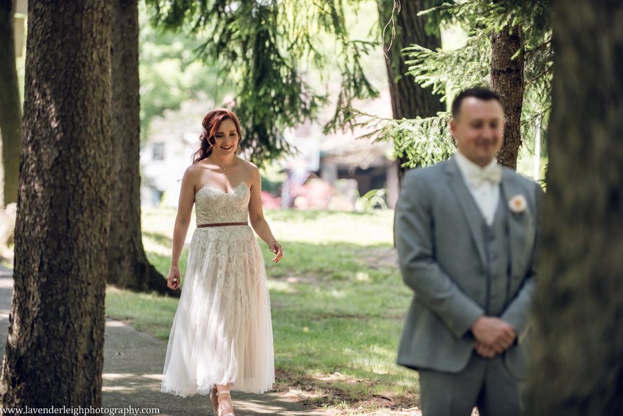 <alt>bride walking towards groom for first look</alt>