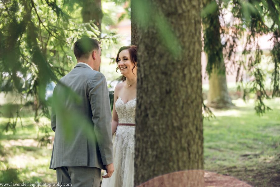 <alt>bride smiling at groom during first look</alt>
