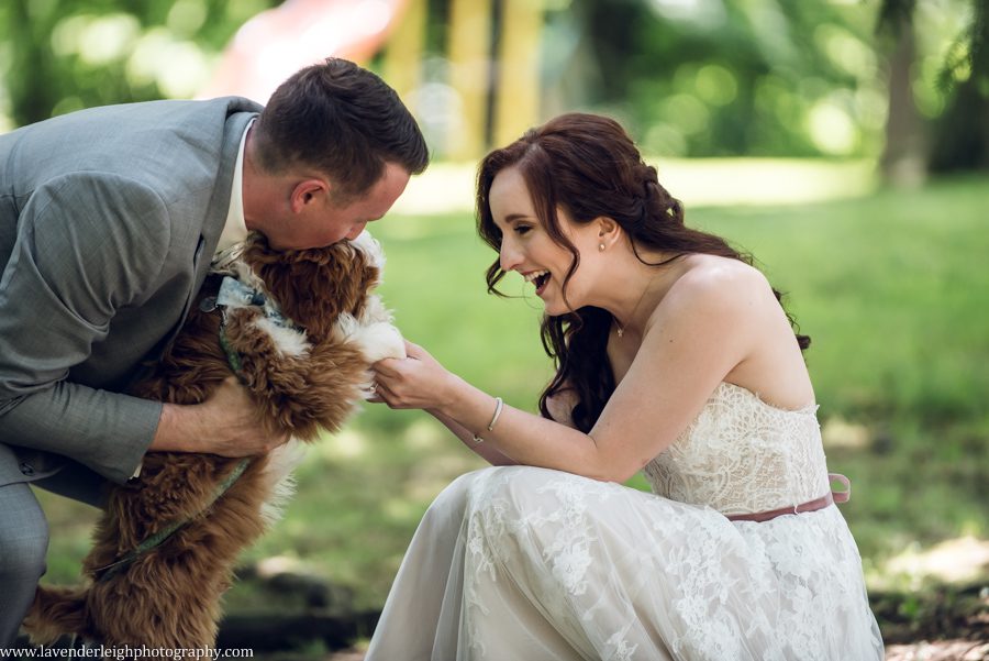<alt>bride and groom with their puppy</alt>