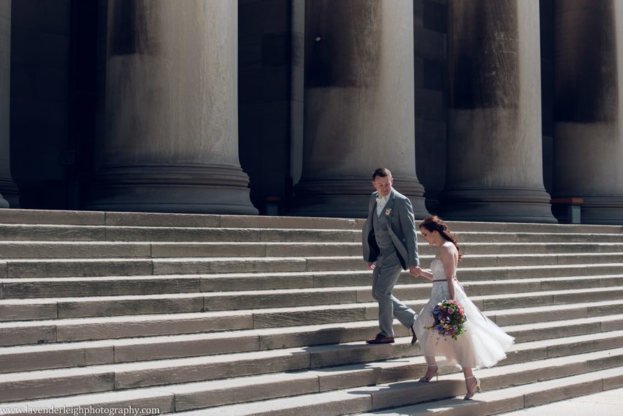 <alt>groom and bride walking up stairs at Mellon University in Pittsburgh, Pennsylvania</alt>